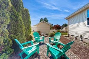 four green chairs sitting in a yard next to a building at Ocean Way Estates - 32563 W Riga Dr in Ocean View