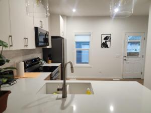 a kitchen with a sink and a faucet at Edmonton 3BR House in Edmonton