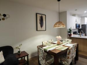 a dining room table and chairs in a living room at Edmonton 3BR House in Edmonton +15 photos