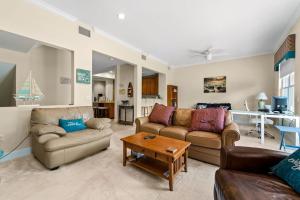 a living room with two couches and a table at White Coral in Placida