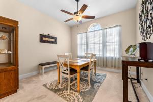 a dining room with a table and a ceiling fan at White Coral in Placida