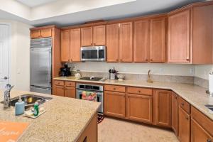a kitchen with wooden cabinets and a counter top at White Coral in Placida +20 photos