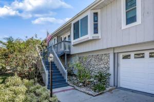 a house with a staircase and an american flag at Madagascar Palm in Marco Island