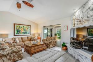 a living room with a couch and a fireplace at Madagascar Palm in Marco Island