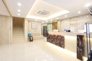 a lobby of a hotel with a reception counter at Busan Seomyeon Nestly Hotel in Busan