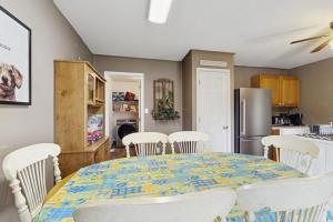 a kitchen with a table with chairs and a refrigerator at Moose's House --- 70 Radcliffe Rd. in The Plantations