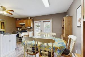 a dining room with a table and chairs in a kitchen at Moose's House --- 70 Radcliffe Rd. in The Plantations +34 photos