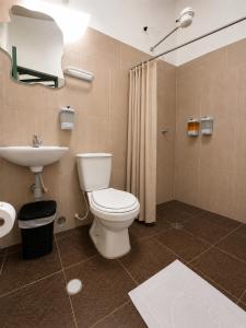 a bathroom with a toilet and a sink at Hotel Altair in Villa de Leyva +18 photos