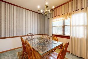a dining room with a table and chairs and a chandelier at Salt Pond --- 669 Bethany Loop in Bethany Beach