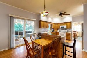a kitchen with a wooden table and a dining room at Salt Pond --- 669 Bethany Loop in Bethany Beach +15 photos