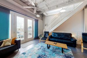 a living room with a couch and a table at Rehoboth Beach -- Forj Lofts #8 in Rehoboth Beach