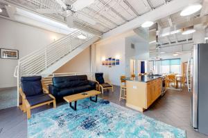 a living room with a couch and chairs and a table at Rehoboth Beach -- Forj Lofts #8 in Rehoboth Beach