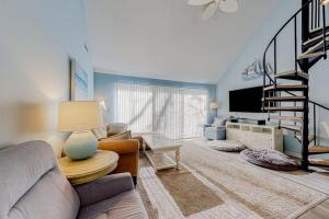 a living room with a couch and a tv at Sea Colony --- 2403 Round Robin in Bethany Beach