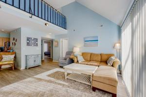 a living room with a couch and a table at Sea Colony --- 2403 Round Robin in Bethany Beach