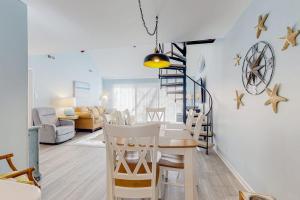 a dining room and living room with a table and chairs at Sea Colony --- 2403 Round Robin in Bethany Beach +30 photos