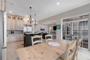 a kitchen and dining room with a wooden table and chairs at Edgewater Acres --- 38874 Old Lighthouse Rd in Selbyville