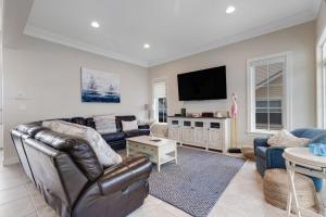 a living room with a couch and a flat screen tv at Edgewater Acres --- 38874 Old Lighthouse Rd in Selbyville