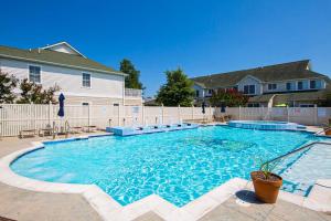 a large swimming pool in front of a house at The Tides --- 19979 Sandy Bottom Cir, Unit #502 in Rehoboth Beach