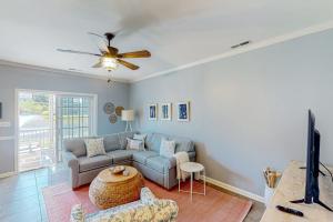 a living room with a couch and a ceiling fan at The Tides --- 19979 Sandy Bottom Cir, Unit #502 in Rehoboth Beach