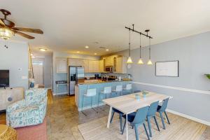 a kitchen and living room with a table and chairs at The Tides --- 19979 Sandy Bottom Cir, Unit #502 in Rehoboth Beach