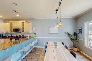 a dining room with a long table and chairs at The Tides --- 19979 Sandy Bottom Cir, Unit #502 in Rehoboth Beach