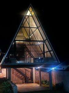 a house with a glass roof at night at Chalés Alto Caparaó in Caparaó Velho