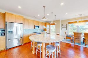a kitchen with a large island with a counter top at Watermark North --- 38918 Silver Sands Dr in Bethany Beach