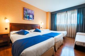 Łóżko lub łóżka w pokoju w obiekcie Hotel Las Provincias