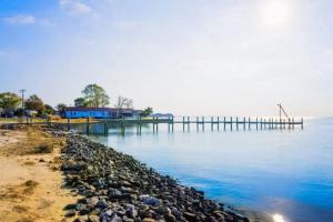 a dock on a body of water with rocks at Rehoboth Beach --- 18 Sabrina Dr in Lewes