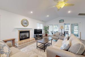 a living room with a couch and a fireplace at Salt Pond - 1 Heron Ct in Bethany Beach