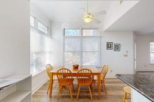 a kitchen with a table with chairs and a ceiling fan at Salt Pond - 1 Heron Ct in Bethany Beach