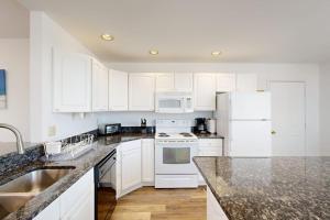 a white kitchen with white appliances and white cabinets at Salt Pond - 1 Heron Ct in Bethany Beach +36 photos