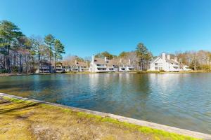 a view of a lake with houses in the background at Sea Colony --- 55084 Pinewood Circle in Bethany Beach