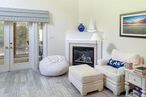 a living room with a chair and a fireplace at Sea Colony --- 55084 Pinewood Circle in Bethany Beach +31 photos