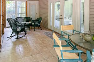 a screened in porch with chairs and a table at Sea Colony --- 55084 Pinewood Circle in Bethany Beach
