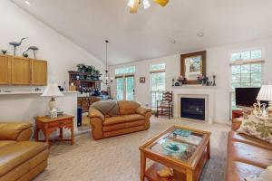 a living room with a couch and a fireplace at South Hampton --- 33549 Water Mill Ln in Ocean View