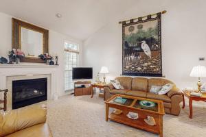 a living room with a couch and a fireplace at South Hampton --- 33549 Water Mill Ln in Ocean View
