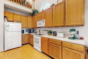 a kitchen with white appliances and wooden cabinets at South Hampton --- 33549 Water Mill Ln in Ocean View