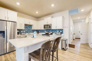 a kitchen with white cabinets and a white counter top at Millville By The Sea in Millville