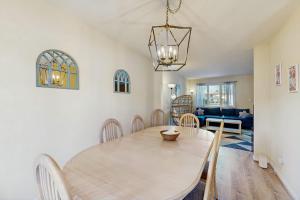 a dining room and living room with a table and chairs at Bethany Pines - 431 Bethany Pines in Bethany Beach