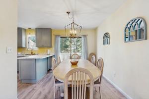 a kitchen and dining room with a table and chairs at Bethany Pines - 431 Bethany Pines in Bethany Beach