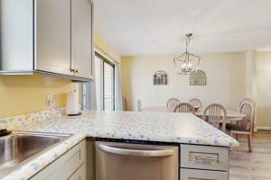 a kitchen with a sink and a counter top at Bethany Pines - 431 Bethany Pines in Bethany Beach +8 photos