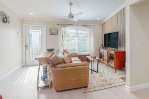 a living room with a couch and a television at Mango House in Naples