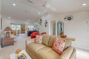 a living room with a brown couch and a living room at Mango House in Naples