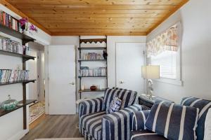 a living room with two chairs and a table at Neck Village in Ocean View +17 photos