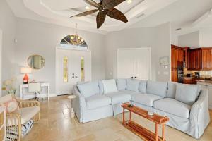 a living room with a couch and a ceiling fan at Marco Paradise in Marco Island