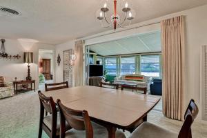 a dining room with a table and chairs and a living room at Tarpon Lagoon in Port Charlotte