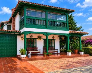 a house with a dog sitting in front of it at Hotel Altair in Villa de Leyva