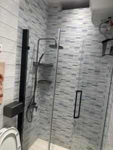 a bathroom with a glass shower with a toilet at Résidence MBK in Ziguinchor +37 photos