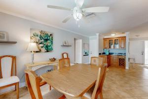 a dining room with a table and a ceiling fan at Seaside Serenity in Punta Gorda +20 photos